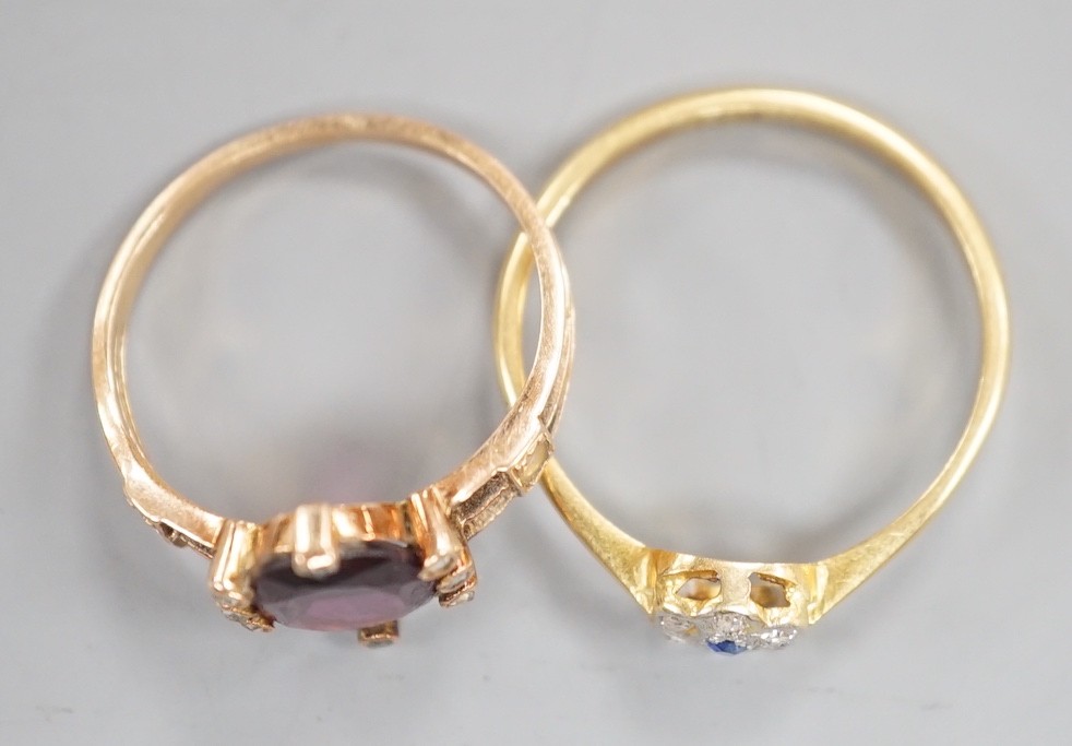 A small 1920's 18ct, sapphire and diamond cluster set flower head ring, size P/Q, gross weight 2.3 grams and a yellow metal, garnet?, split pearl and diamond chip set oval cluster ring, gross weight 2 grams.